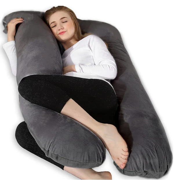 A pregnant woman sleeping comfortably on her side with a grey Chilling Home U-shaped pregnancy pillow.
