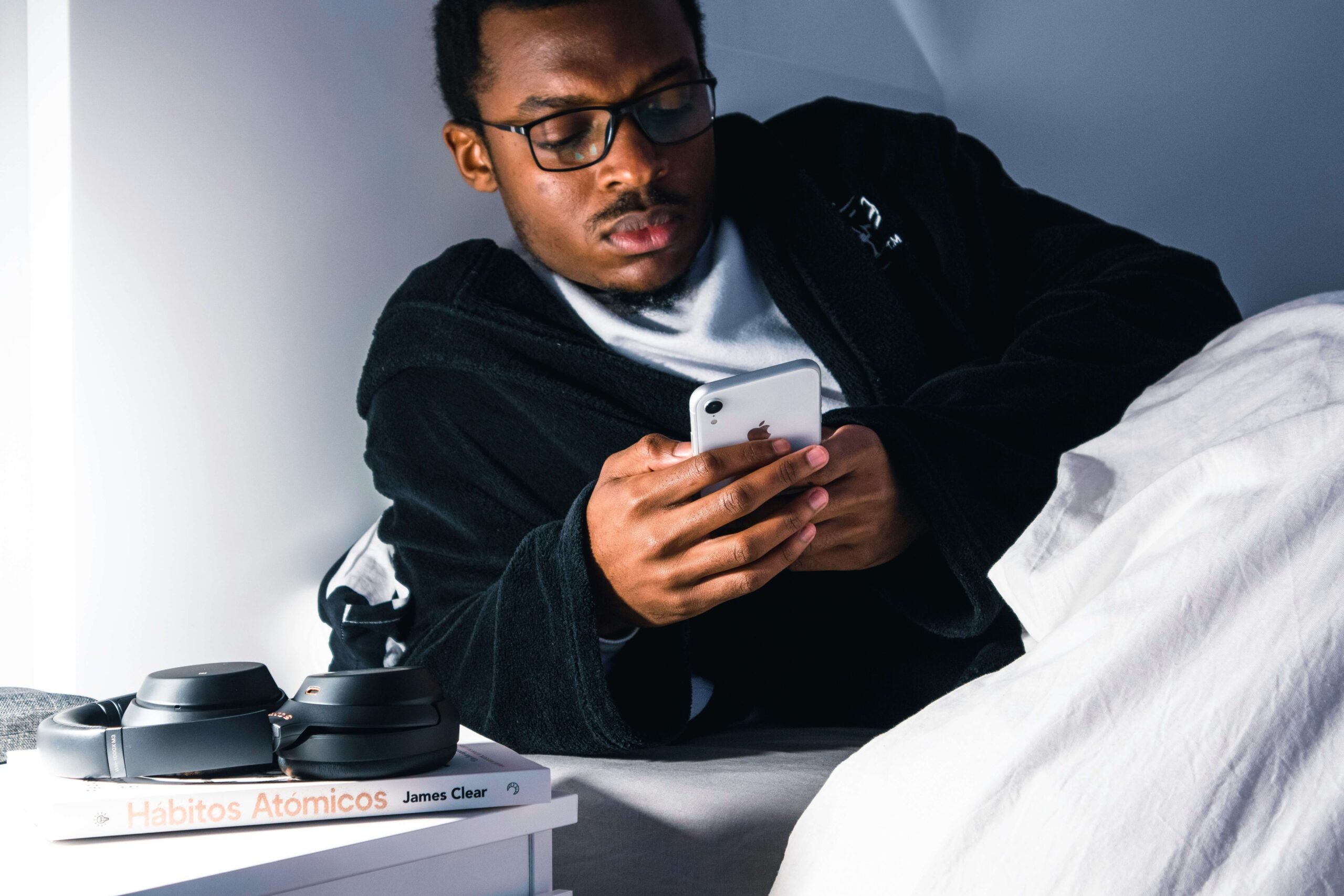 a man is looking at his phone before going to sleep