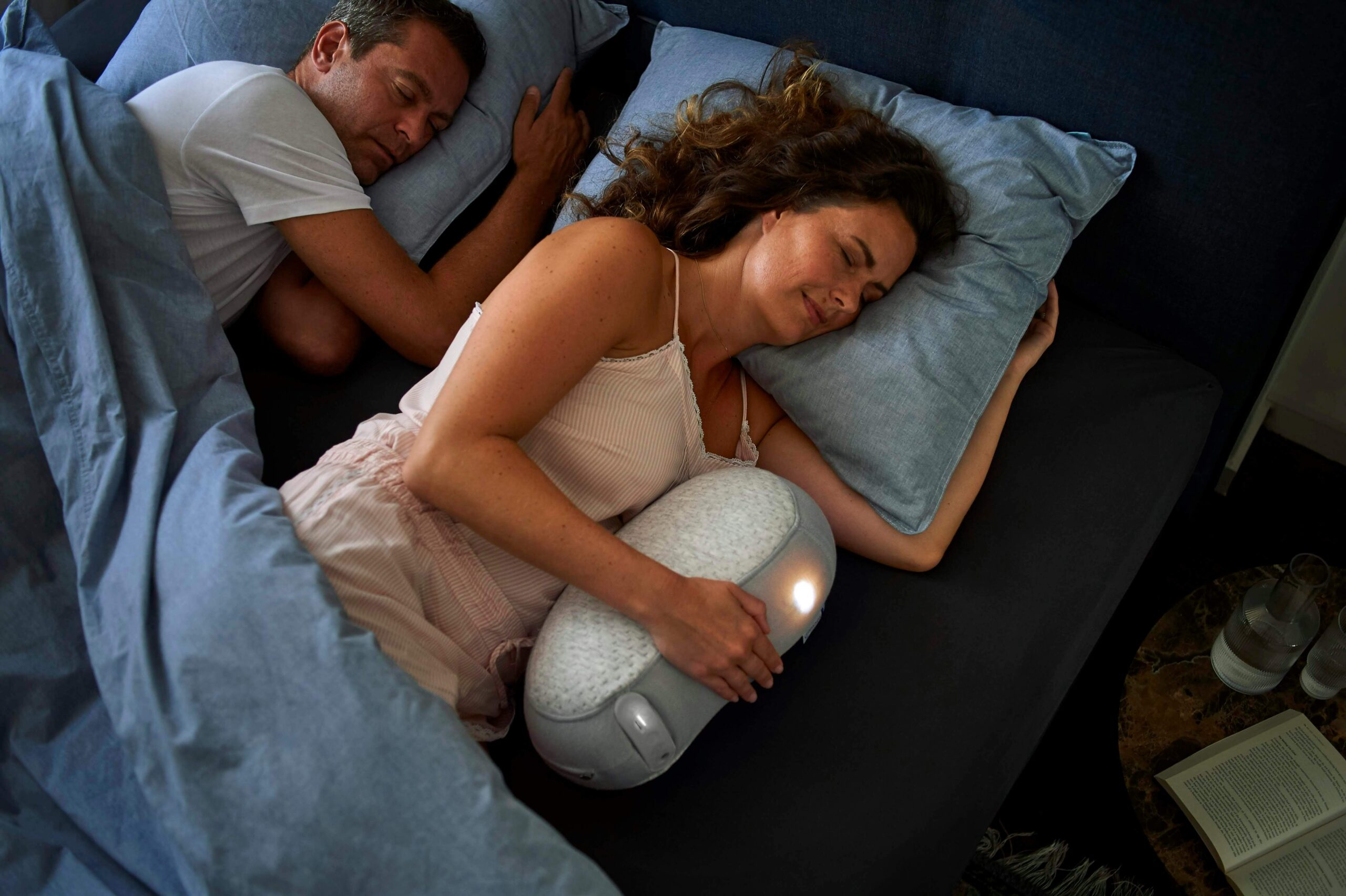 a couple is sleeping soundly as they have good product for bedroom such as pillow, blanket and mattress